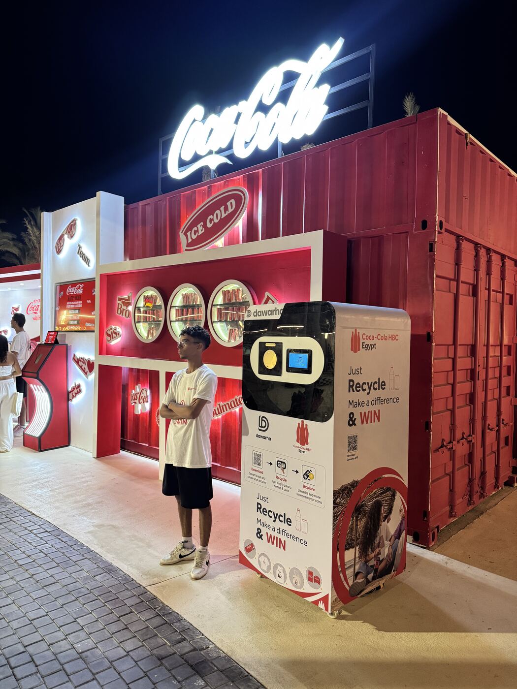 A Coca-Cola HBC Egypt co-branded Dawarha machine at a beachfront activation at night